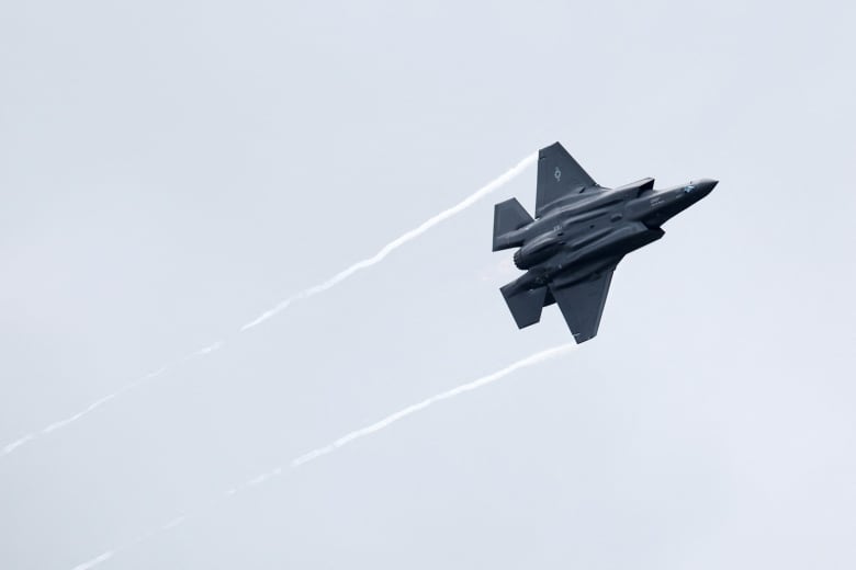 A F-35 fighter jet performing in the sky.