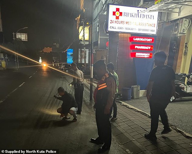 North Kuta police examine the location outside the clinic where Mr Bradley was found