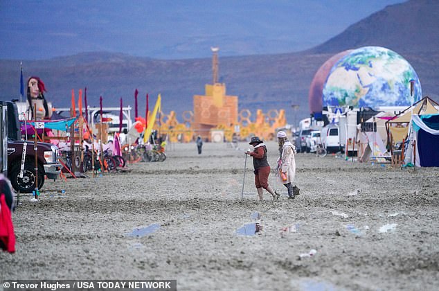 Dawn on Saturday brought a muddy realization to the Burning Man encampment, where the exit gates remain closed indefinitely