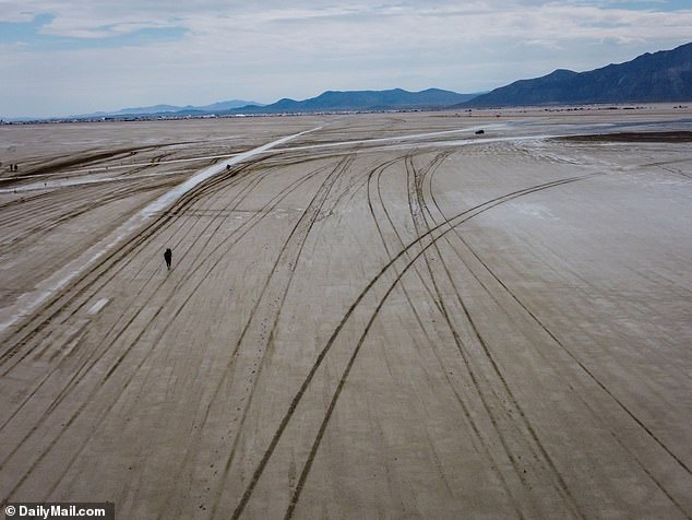 Tracks left by vehicles coming into and out of the site can be seen on the desert floor