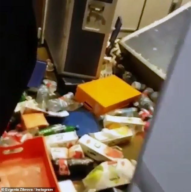 Drink and food cartons are seen knocked over the floor during the flight from Russia to Thailand