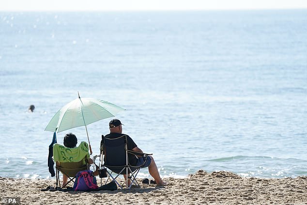 People enjoying the warm weather on Bournemouth beach in Dorset today