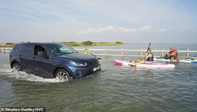 Paddle boarders made the most of the high tide at The Strood, West Mersea near Colchester this afternoon