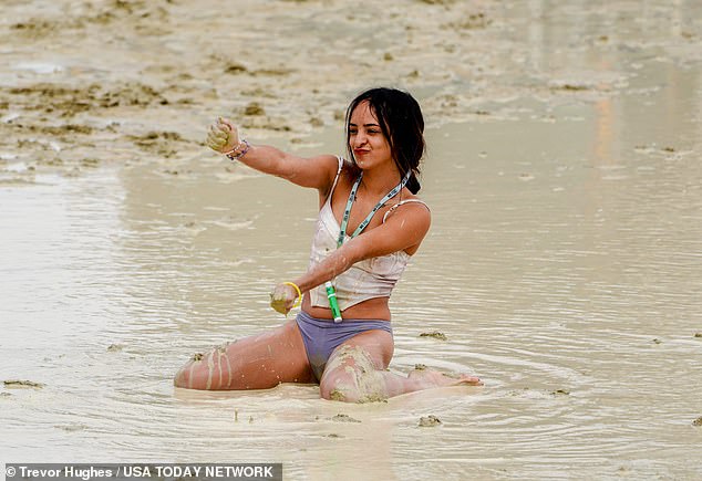 Shai Peza of Chicago frolics in the mud and water at Burning Man on Saturday