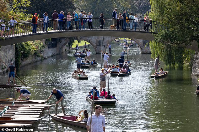 People enjoy the warm weather while out punting on the River Cam in Cambridge on Sunday