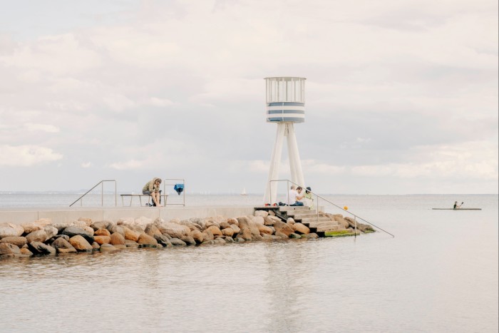 A small modernist watchtower by Arne Jacobsen at the end of a concrete jetty at Bellevue beach