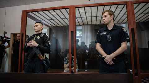 Police members in the courtroom during the trial for the former military commissar Yevhen Borysov in Kyiv, Ukraine.