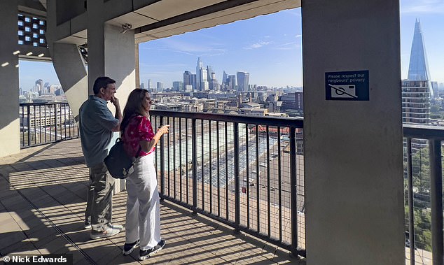 Visitors are seen today on the exterior walkway at the re-opened top floor viewing gallery at the Tate Modern