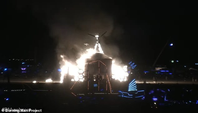 The giant effigy is seen being lit on Monday in the Nevada desert