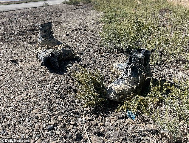 Muddy boots are abandoned by the side of the road on Monday