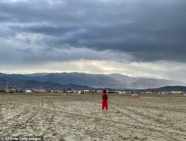 A man surveys the muddy scene in Black Rock, Nevada, on Monday