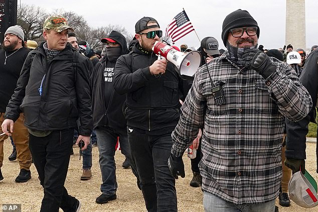 Proud Boys members including Zachary Rehl, left, Ethan Nordean, center, and Joseph Biggs, walk toward the U.S. Capitol in Washington, in support of President Donald Trump