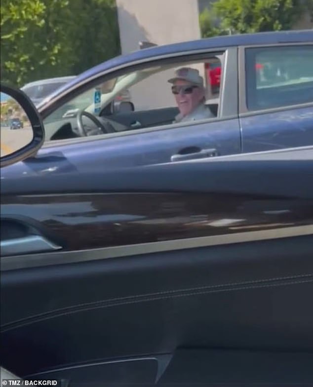 The woman began filming the car chase after the incident - honking her horn and yelling at Busey to stop. He grinned and sped off, eventually pulling over down the road