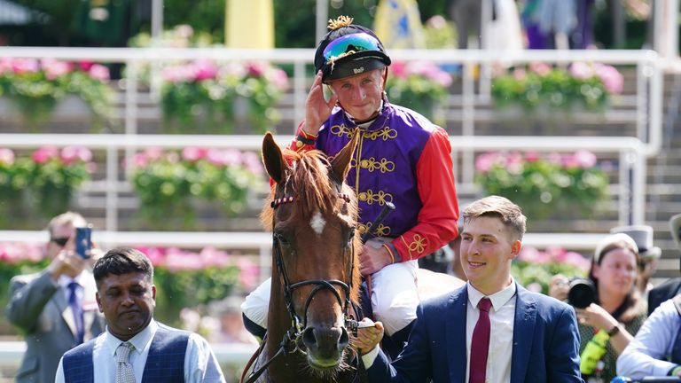 Marquand salutes the Royal box after riding Desert Hero to victory in the colours of The King and Queen