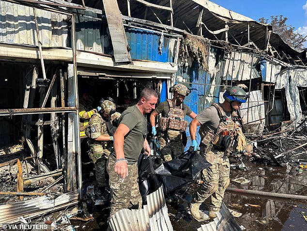 Police officers and rescuers carry a bodybag out of a market following a Russian military strike, amid Russia's attack on Ukraine, in Kostiantynivka, Donetsk region, Ukraine September 6, 2023