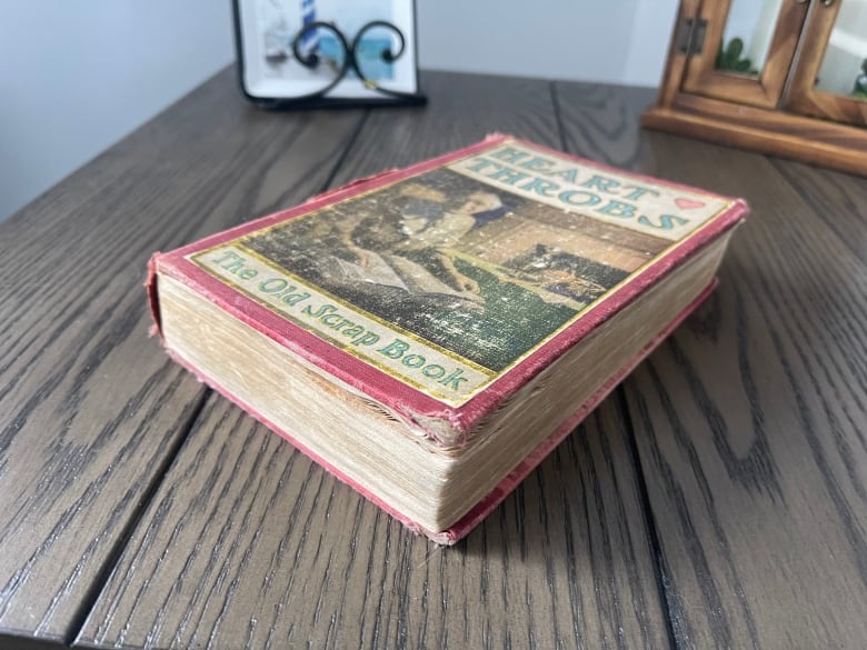 A close-up of a book in Peggy Savery's new home. The book's title is "Heart Throbs: The Old Scrap Book."