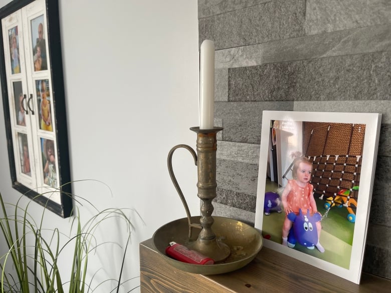 A close-up of a baby photo and a candle inside Peggy Savery's new home.