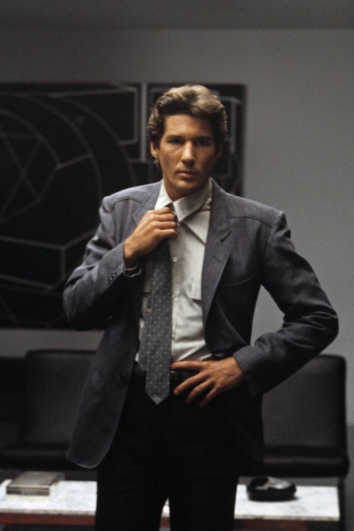 A still from the film American Gigolo with Richard Gere dressed in a smart Armani suit