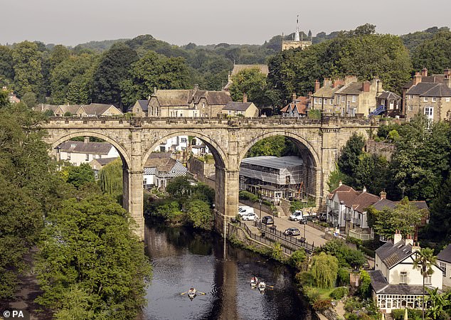 People enjoy the hot weather underneath the Knaresborough Viaduct in North Yorkshire today