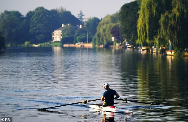 Rowers travel along the River Thames near Maidenhead in Berkshire this morning