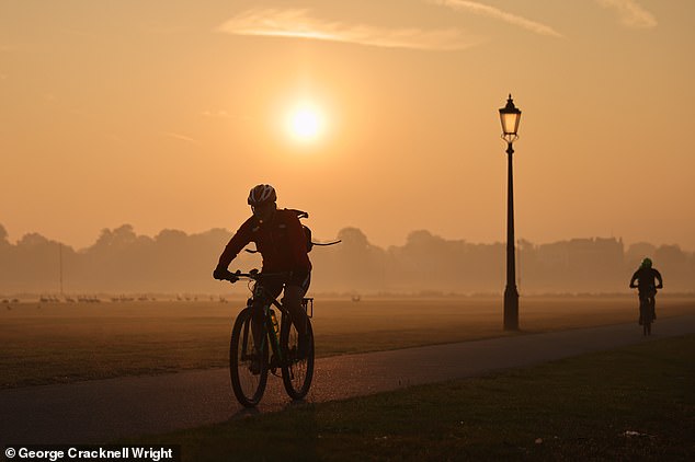 A cyclist rides through Blackheath Common in South East London this morning