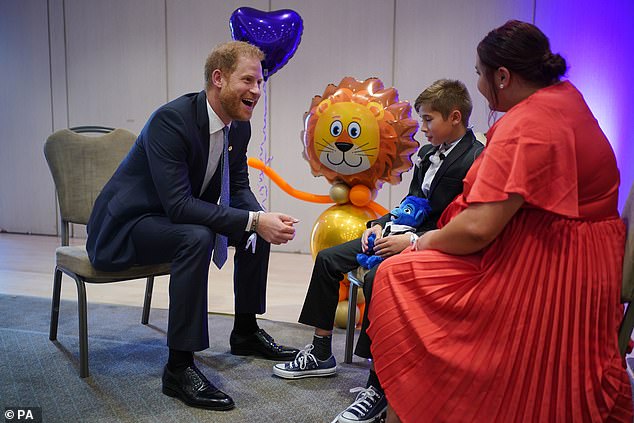 Harry speaks to George Hall and his mother Hollie Pearson during the WellChild Awards 2023