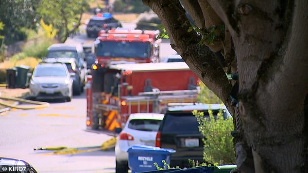 Someone then called 911 and reported a person had died in the burning house. Seattle police said officers tried to enter the home but the doors were barricaded.