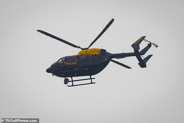 A police helicopter patrols surrounding areas near Richmond Park today as the search for Khalife continues