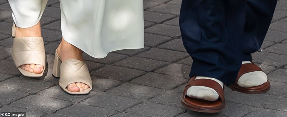 Quite the contrast: While Harper donned a pair of heels, David opted for socks and sandals