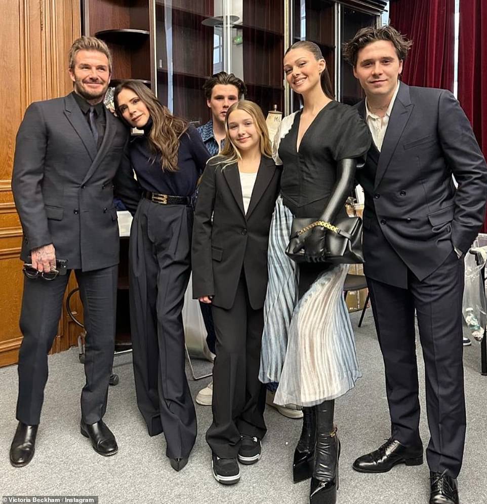 United front: The Beckham clan were out in full force in March for Victoria's Winter Paris Fashion Week show (L-R David, Victoria, Cruz, Harper, Nicola Peltz, Brooklyn)