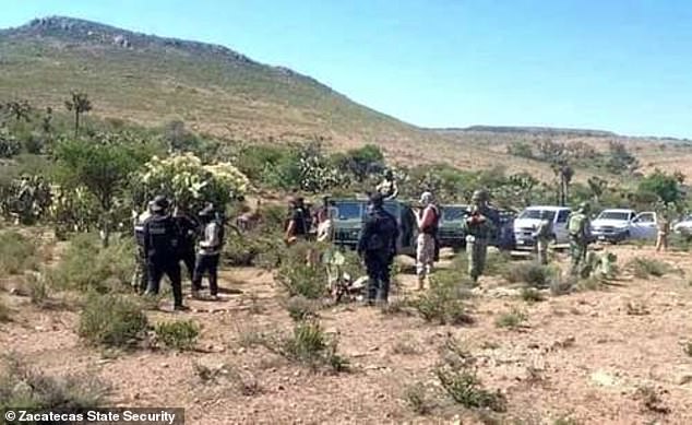 Security forces inspect the farm area where the bodies of six teenagers and a survivor were found Wednesday