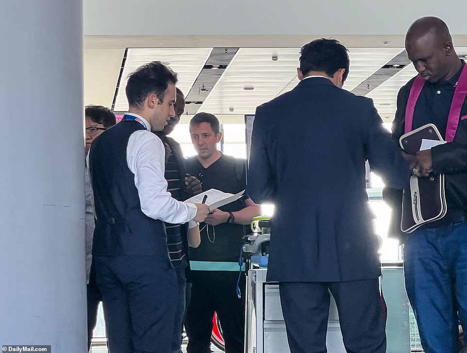 Turkish Airlines employees check documents as Flight 800 fills up for the 13-hour flight that gives hope of a new life in the United States for thousands of Africans each week