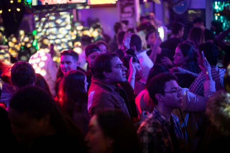 People are pictured dancing during a Latin music event at Mangos Kitchen Bar in Vancouver, British Columbia on Friday, February 18, 2022.