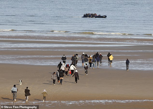 Despite the dinghy already appearing full, at least 32 men, women and children could be seen trying to reach it before it set off