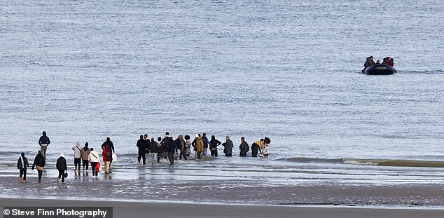 Despite the significant distance between the dinghy and the shore, many were determined to try and climb aboard