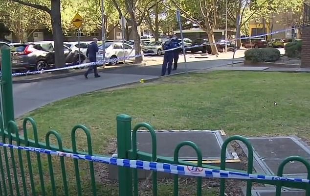 The entrance of the North Melbourne unit complex remained cordoned off on Saturday