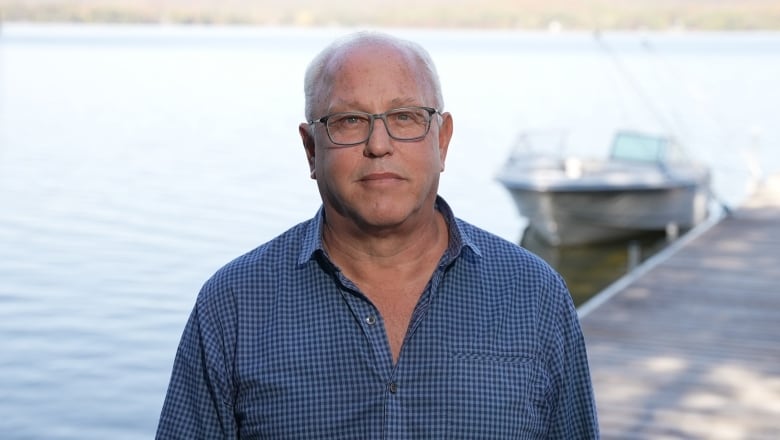 A man stands on a dock.