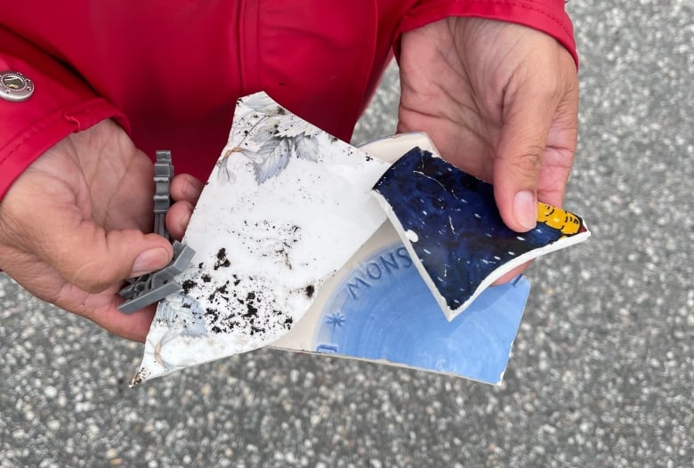 Peggy Savery holds pieces of her belongings that she found on the beach.