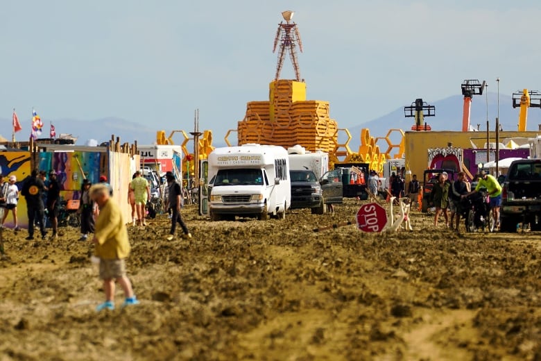 The grounds of the Burning Man encampment are muddy after a rainstorm.