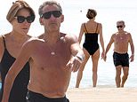 Carla Bruni looks sensational as she strolls on the beach with her husband Nicolas Sarkozy while in Venice for the Film Festival