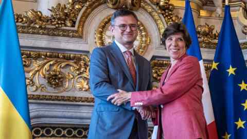 Ukraine’s foreign minister Dmytro Kuleba, left, shakes hands with Catherine Colonna, France’s foreign minister