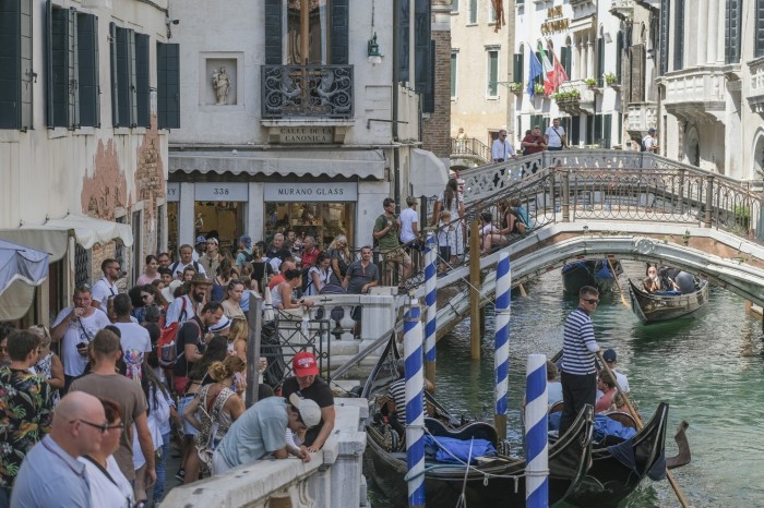 Crowds at a canal near St Mark’s Square in Venice