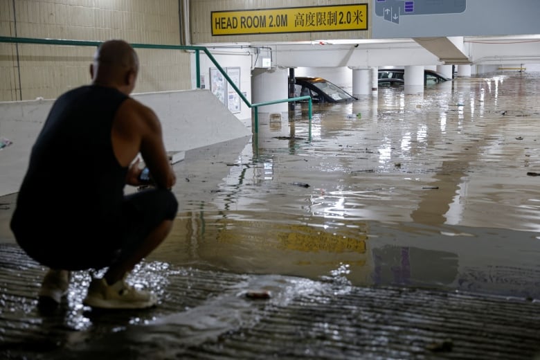 Vehicles are seen in a flooded portion of a parking lot in Hong Kong.