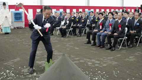 Atsuyoshi Koike, president of semiconductor venture Rapidus, breaks ground during a ceremony in the city of Chitose, northern Japan. where the country’s new chip plant will built