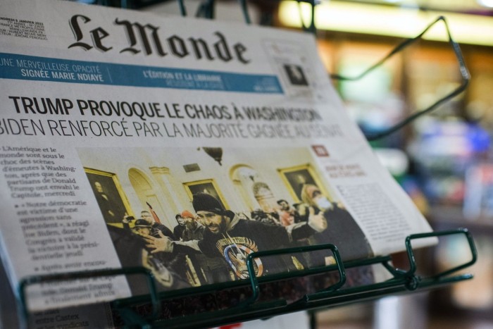 The front page of French newspaper Le Monde on a news stand