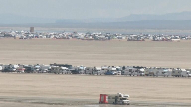 Stream of vehicles leaves Burning Man in exodus from muddy desert