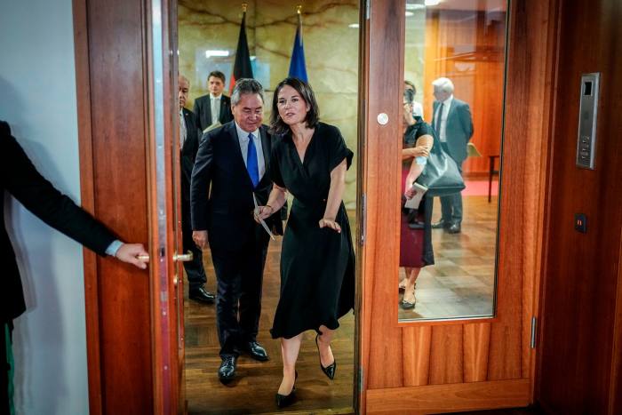 German foreign minister Annalena Baerbock, right, walks with her Kyrgyzstani counterpart Jeenbek Kulubaev in Berlin, August 24, 2023