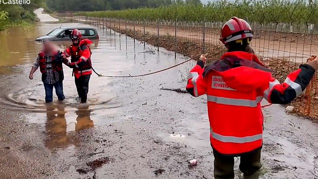 The rain hits Spain… but it’s baking in the UK! Weather warnings are issued as torrential downpours spark floods across Brits’ favourite holiday destination