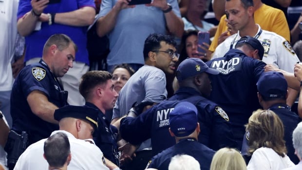 Climate protester glues feet to floor at U.S. Open, interrupting semifinal between Gauff, Muchova