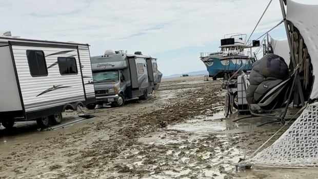 Burning Man attendees told to shelter in place after rain turns Nevada site into muddy, flooded mess